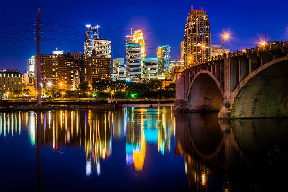 The Central Avenue Bridge and skyline reflecting in the Mississippi River at night, in Minneapolis, Minnesota. The Central Avenue Bridge and skyline reflecting in the Mississippi River at night, in Minneapolis, Minnesota.